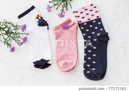 Three pairs of women socks on white background. Three pairs of women socks on white background. 77571583