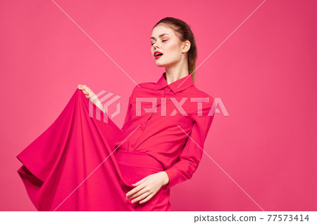 Woman on a pink background in fashionable clothes and bright makeup hairstyle model Copy Space Woman on a pink background in fashionable clothes and bright makeup hairstyle model Copy Space 77573414