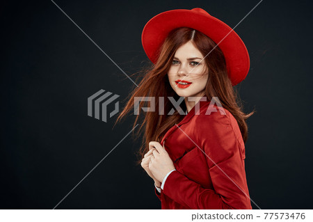 Pretty woman with red lips hat on her head jacket elegant style charm dark isolated background 77573476