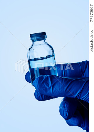 man has a vaccine vial in his hand man has a vaccine vial in his hand 77573667