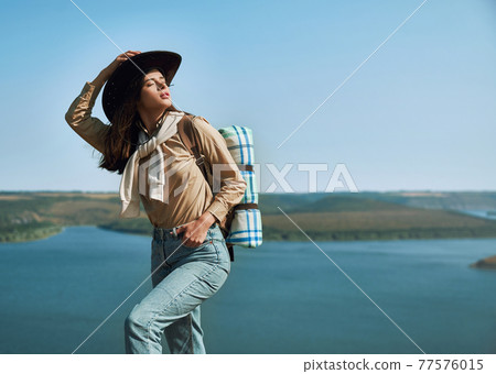 Pleasant woman enjoying sunny weather at Bakota area 77576015