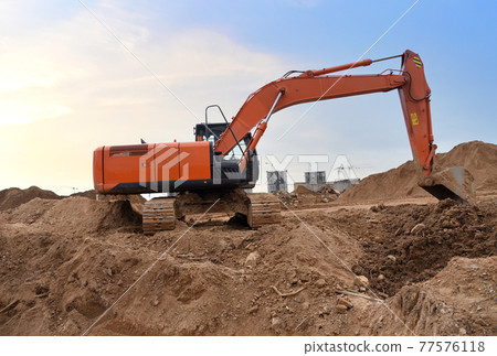 Excavator on earthworks at construction site. Excavator on earthworks at construction site. 77576118