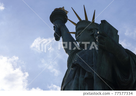 Statue of Liberty silhouette, Statue of Liberty against the sun Statue of Liberty silhouette, Statue of Liberty against the sun 77577334