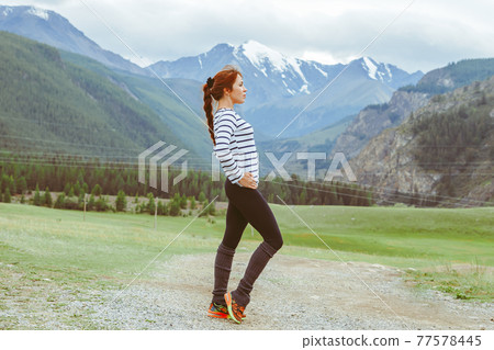 beautiful girl posing on the background of mountains 77578445