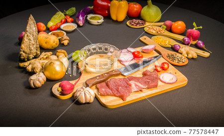 top view Fresh food is placed on a black table top view Fresh food is placed on a black table 77578447
