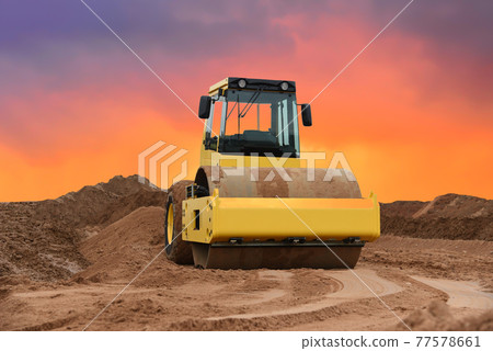 Vibration single-cylinder road roller on amazing sunset background.  77578661