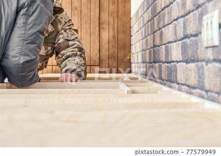 Workers assembles a plywood frame for a kitchen countertop Workers assembles a plywood frame for a kitchen countertop 77579949