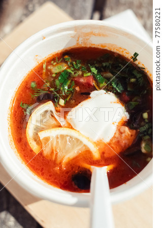 Close-up of a hodgepodge in a disposable paper cup. The concept of traditional food and foreign cuisine. Safe eco-friendly disposable tableware. Close-up of a hodgepodge in a disposable paper cup. The concept of traditional food and foreign cuisine. Safe eco-friendly disposable tableware. 77580221
