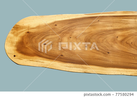 Texture of live edge suar wood slab on blue background Texture of live edge suar wood slab on blue background 77580294