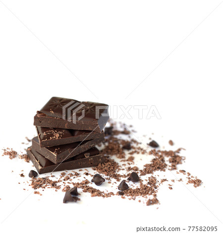 Dark chocolate stack with flakes powder isolated on white background Dark chocolate stack with flakes powder isolated on white background 77582095