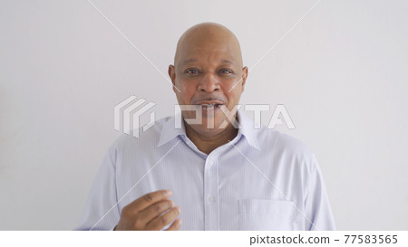 Portrait of happy smiling senior old elderly business Black African American man person talking in conference in technology device isolated on white background. Portrait of happy smiling senior old elderly business Black African American man person talking in conference in technology device isolated on white background. 77583565