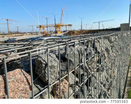 Iron metal mesh reinforcement on a concrete wall in the construction of houses by industrial methods with the help of cranes Iron metal mesh reinforcement on a concrete wall in the construction of houses by industrial methods with the help of cranes 77585383