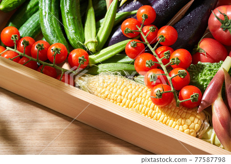 Summer vegetables in a wooden box Summer vegetables in a wooden box 77587798