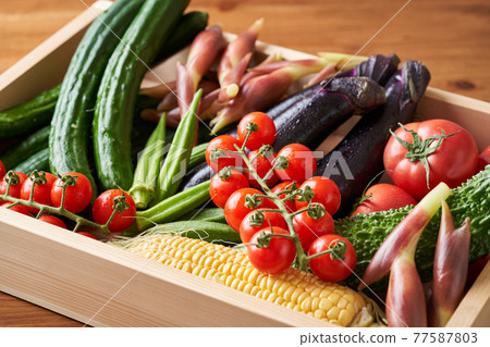 Summer vegetables in a wooden box 77587803