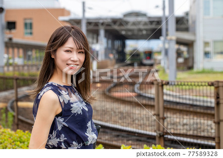 廣島港電車站背景下的微笑女性 77589328