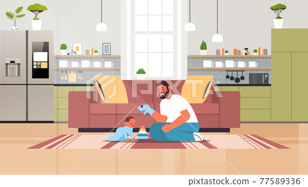 young father playing with little son at home fatherhood parenting concept dad spending time with his kid young father playing with little son at home fatherhood parenting concept dad spending time with his kid 77589336
