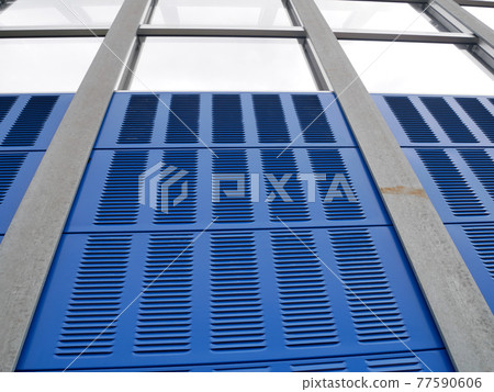 SELANGOR, MALAYSIA - JULY 5, 2020: Noise barriers are installed along the vehicle lane bordering the residence to prevent noise pollution to the surrounding locals. 77590606