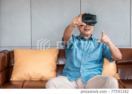 asian senior man enjoying when wearing VR headsets(vintage tone) 77591382