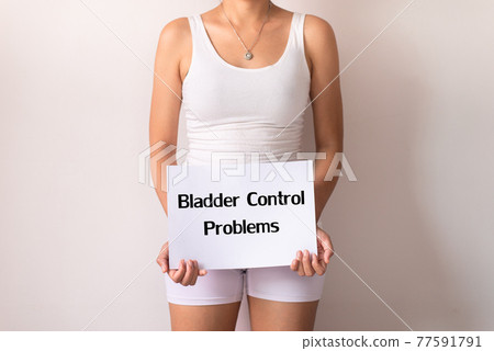 Woman hands holding a white sign with the word bladder control problem on white background Woman hands holding a white sign with the word bladder control problem on white background 77591791
