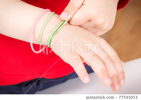 Preschooler playing with rubber erasers. Development of kids motor skills Preschooler playing with rubber erasers. Development of kids motor skills 77593053
