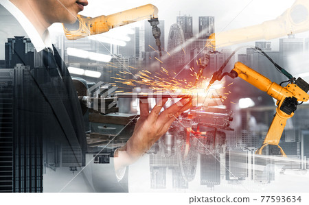 Mechanized industry robot arm and factory worker double exposure 77593634