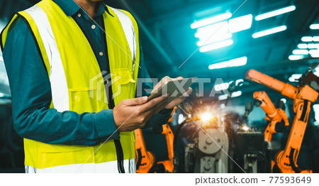 Engineer use advanced robotic software to control industry robot arm in factory 77593649