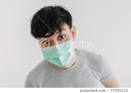Close up of Happy man wears mask isolated on white background. Close up of Happy man wears mask isolated on white background. 77595125