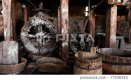 An ancient hand mill made of stones and wood. Flour grinding device An ancient hand mill made of stones and wood. Flour grinding device 77596563