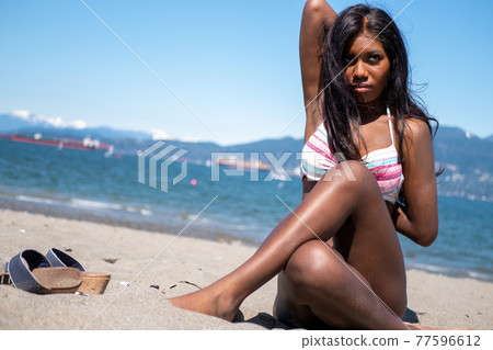 A black Canadian girl in a bikini doing yoga on Stock Photo