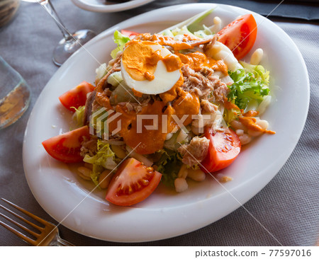 Fresh Catalan salad with Xatonada sauce Fresh Catalan salad with Xatonada sauce 77597016