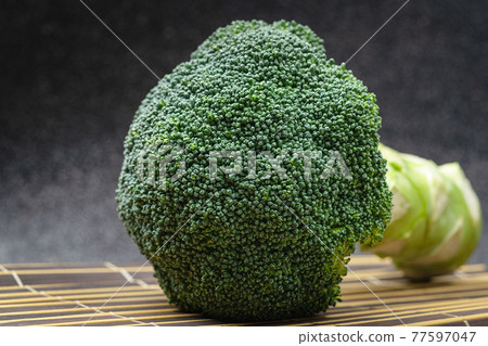 Close up'Broccoli on a black background. 77597047