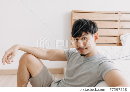 Man relax in his apartment while in quarantine stay at home. Man relax in his apartment while in quarantine stay at home. 77597238