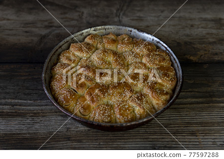 Homemade baked bread on rustic wooden background Homemade baked bread on rustic wooden background 77597288