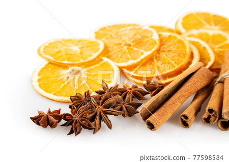 Dried oranges and spices on a white background Dried oranges and spices on a white background 77598584