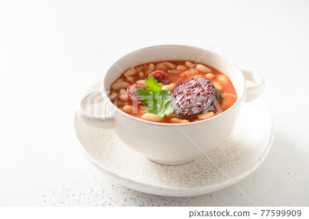 Spanish fabada on white table. Close up. Spanish fabada on white table. Close up. 77599909