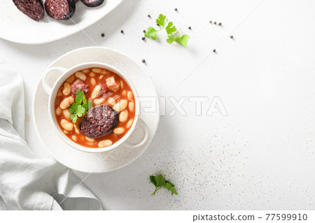 Spanish asturiana fabada on white table. Copy space 77599910