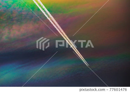 A rare sight: iridescent clouds with a plane. Diffraction can make clouds shine with colours like a corona. A rare sight: iridescent clouds with a plane. Diffraction can make clouds shine with colours like a corona. 77601476