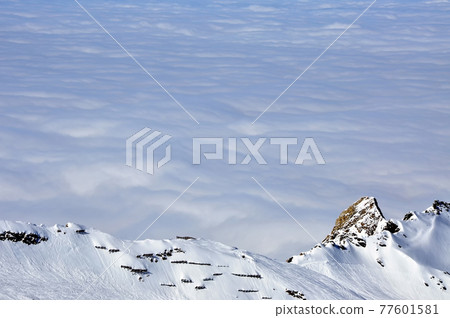 Ski resort in the Alps. Ski slopes, piste, powder snow in the mountains Ski resort in the Alps. Ski slopes, piste, powder snow in the mountains 77601581