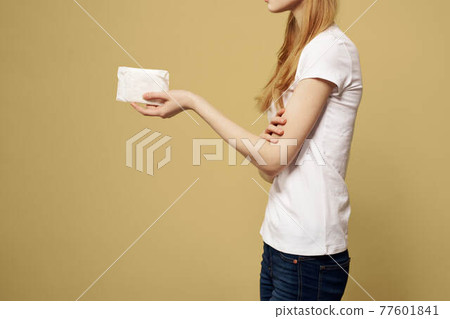 Woman with pad in hand on beige background cropped side view 77601841