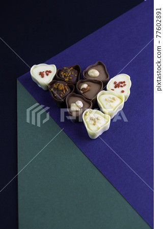 chocolate assortment candies isolated on geometric box 77602891