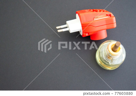 Disassembled electric mosquito repellent red on a gray background. Protection from mosquitoes at home. Copy space, isolated Disassembled electric mosquito repellent red on a gray background. Protection from mosquitoes at home. Copy space, isolated 77603880