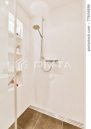 Shower tap in tiled bathroom Shower tap in tiled bathroom 77604896