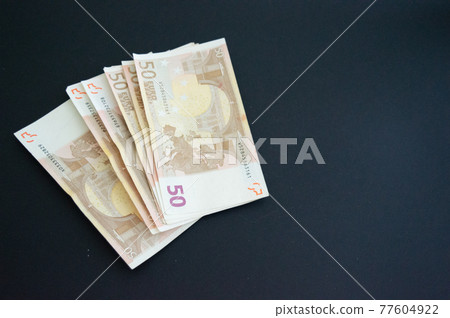 bunch of 50 euro banknotes from the European Union.Copy space.Location on the edge, on the side. Grey background bunch of 50 euro banknotes from the European Union.Copy space.Location on the edge, on the side. Grey background 77604922