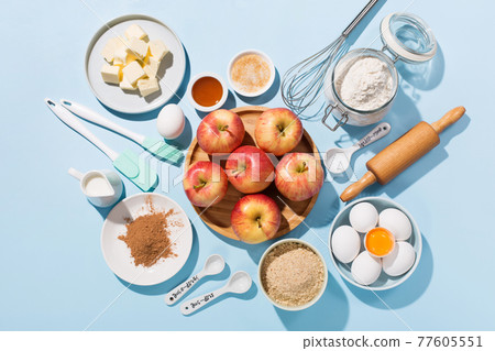 Cooking baking background with ingredients, fresh apples, spices and utensils on blue table. Cooking baking background with ingredients, fresh apples, spices and utensils on blue table. 77605551