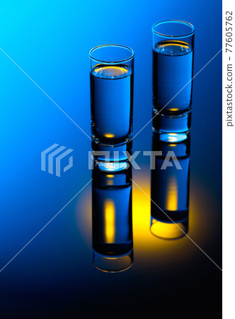 Strong alcoholic drink in color bright lights. Strong alcoholic drink in color bright lights. 77605762