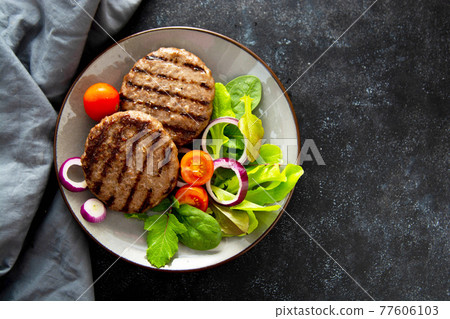 Cooked minced beef patty with vegetables. Copy space Cooked minced beef patty with vegetables. Copy space 77606103