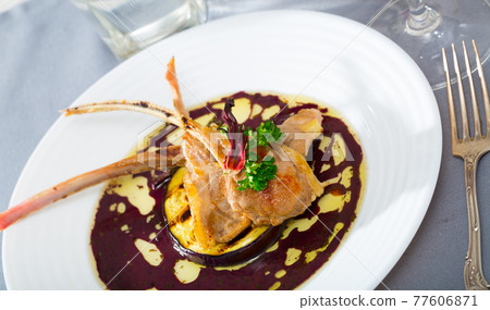 Baked lamb ribs with eggplant, wine sauce, dried hibiscus 77606871