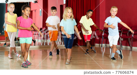 Boys and girls having dancing class in studio 77606874