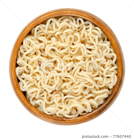 Cooked instant noodles in a wooden bowl. Boiled instant ramen. Noodles, sold in precooked and dried block form, to be soaked in boiling water, but can be also consumed dry. Isolated macro food photo. Cooked instant noodles in a wooden bowl. Boiled instant ramen. Noodles, sold in precooked and dried block form, to be soaked in boiling water, but can be also consumed dry. Isolated macro food photo. 77607440