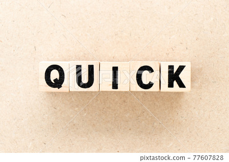 Alphabet letter block in word quick on wood background 77607828